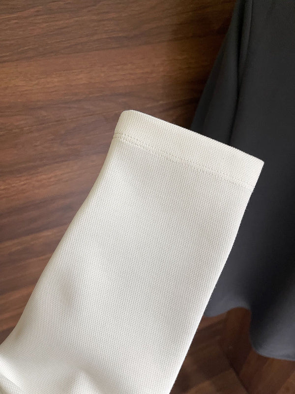Flat lay presentation of Louis Vuitton luxury clothing with label-forward styling