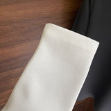 Flat lay presentation of Louis Vuitton luxury clothing with label-forward styling