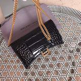 Styled lifestyle shot of sleek polished women's handbag – women's luxury handbag