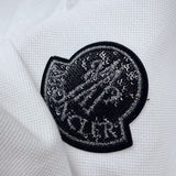 Front view of Moncler luxury clothing with logo-detail design