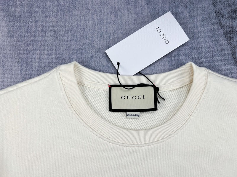 Close-up detail shot of Gucci luxury clothing with signature branding