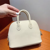 Side view of poised structured handbag