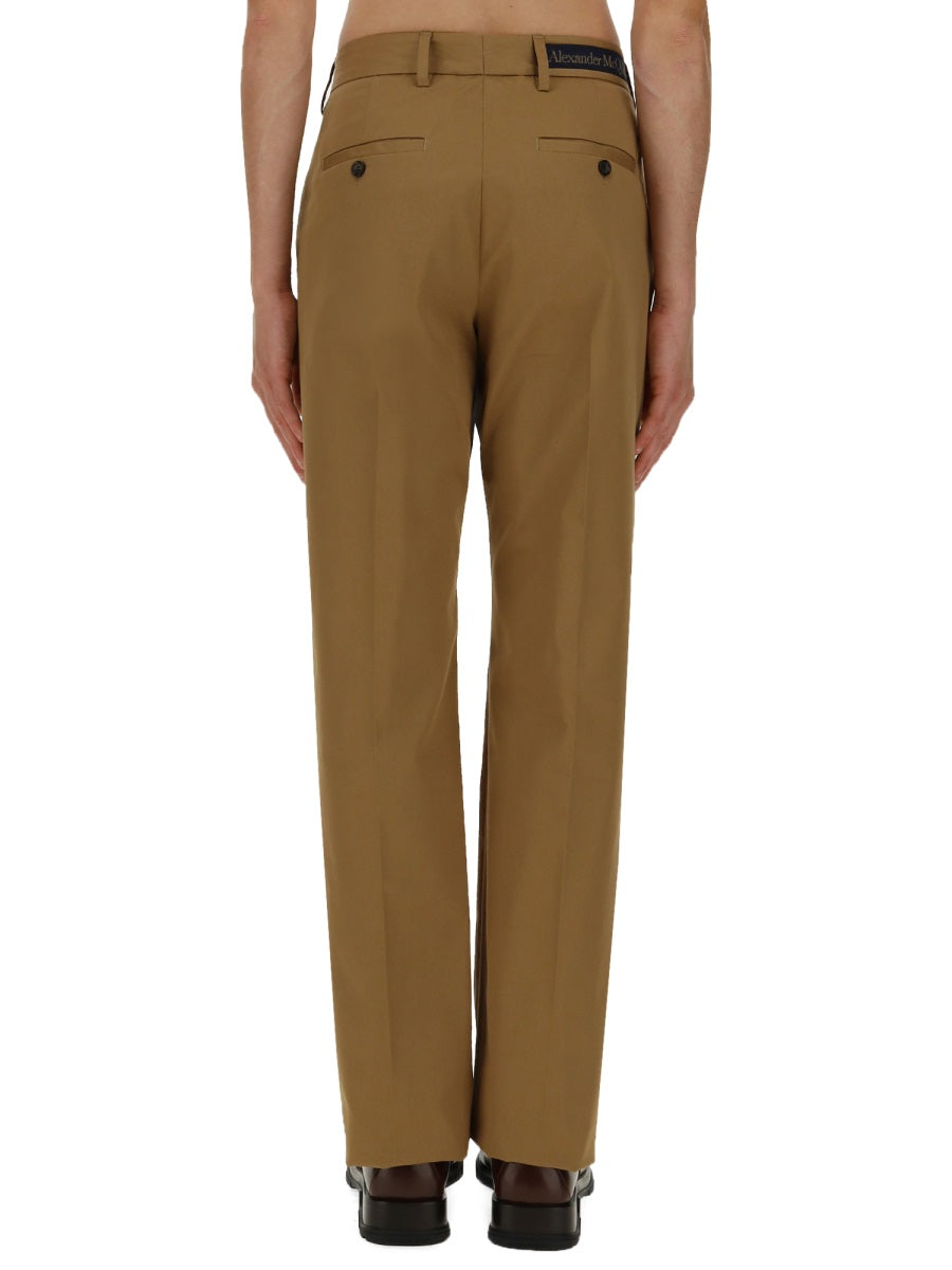 Close-up of Alexander McQueen pants hardware and fine stitching