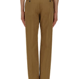 Close-up of Alexander McQueen pants hardware and fine stitching