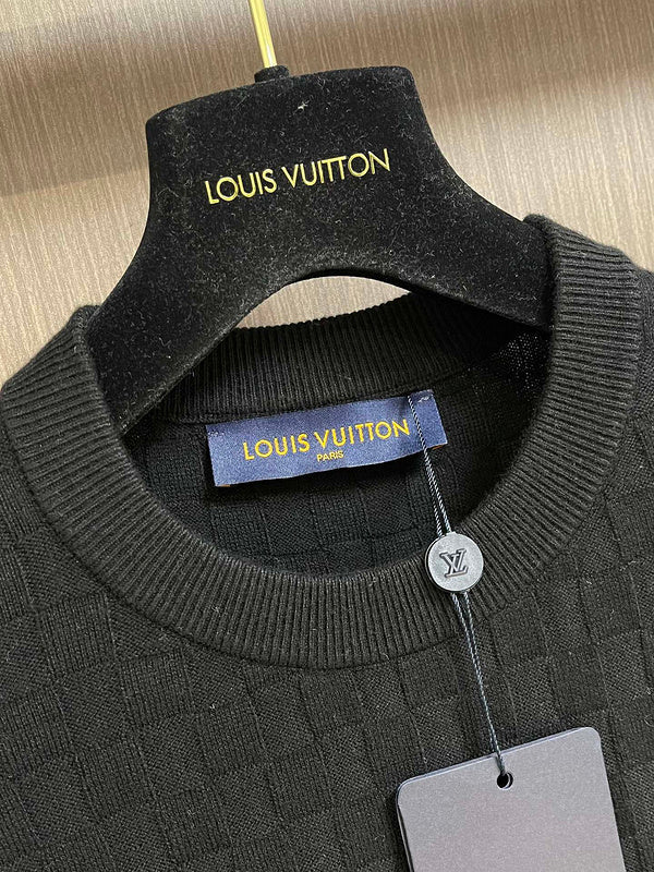Close-up detail shot of Louis Vuitton luxury clothing with label-forward styling
