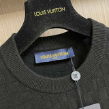 Close-up detail shot of Louis Vuitton luxury clothing with label-forward styling