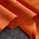 Flat lay presentation of Louis Vuitton luxury clothing with label-forward styling