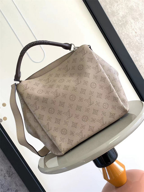  Signature top-handle bag carried on shoulder