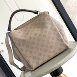  Signature top-handle bag carried on shoulder