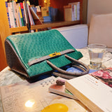 Side view of streamlined structured handbag