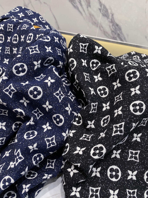 Close-up detail shot of Louis Vuitton luxury clothing with logo-detail design