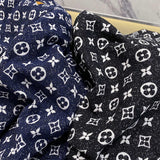 Close-up detail shot of Louis Vuitton luxury clothing with logo-detail design