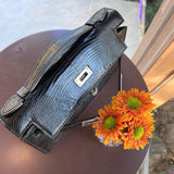 Side view of poised structured handbag