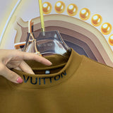 Flat lay presentation of Louis Vuitton luxury clothing with monogram-inspired silhouette