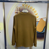Side profile of Louis Vuitton luxury clothing with monogram-inspired silhouette