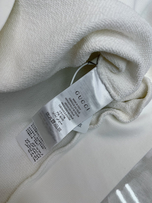 Close-up detail shot of Gucci luxury clothing with monogram-inspired silhouette