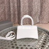 Styled lifestyle shot of structured signature women's handbag – women's premium purse