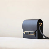  Understated crossbody bag carried on shoulder