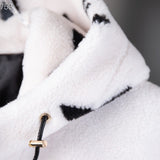 Flat lay presentation of Louis Vuitton luxury clothing with signature branding