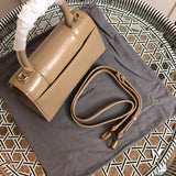 Handle and strap detail of modern statement women's handbag – women's luxury handbag