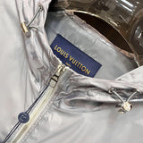 Flat lay presentation of Louis Vuitton luxury clothing with label-forward styling