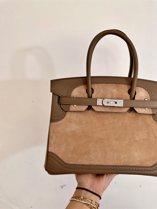  polished top-handle bag detail view showing craftsmanship