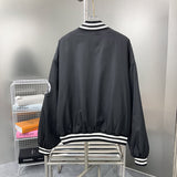 Side profile of Louis Vuitton luxury clothing with label-forward styling