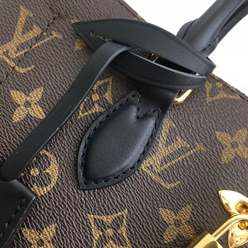 Handle and strap detail of polished elevated women's handbag – women's luxury accessory