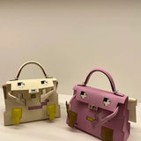  Graceful top-handle bag carried on shoulder