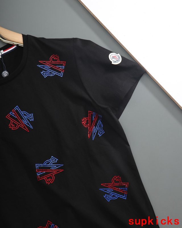 Flat lay presentation of Moncler luxury clothing with relaxed-fit cut