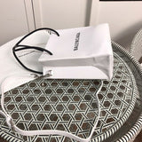 Styled lifestyle shot of structured statement women's handbag – women's luxury handbag