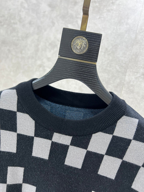 Close-up detail shot of Louis Vuitton luxury clothing with logo-detail design