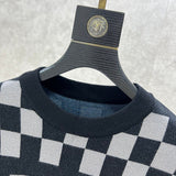 Close-up detail shot of Louis Vuitton luxury clothing with logo-detail design
