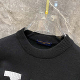 Side profile of Louis Vuitton luxury clothing with label-forward styling