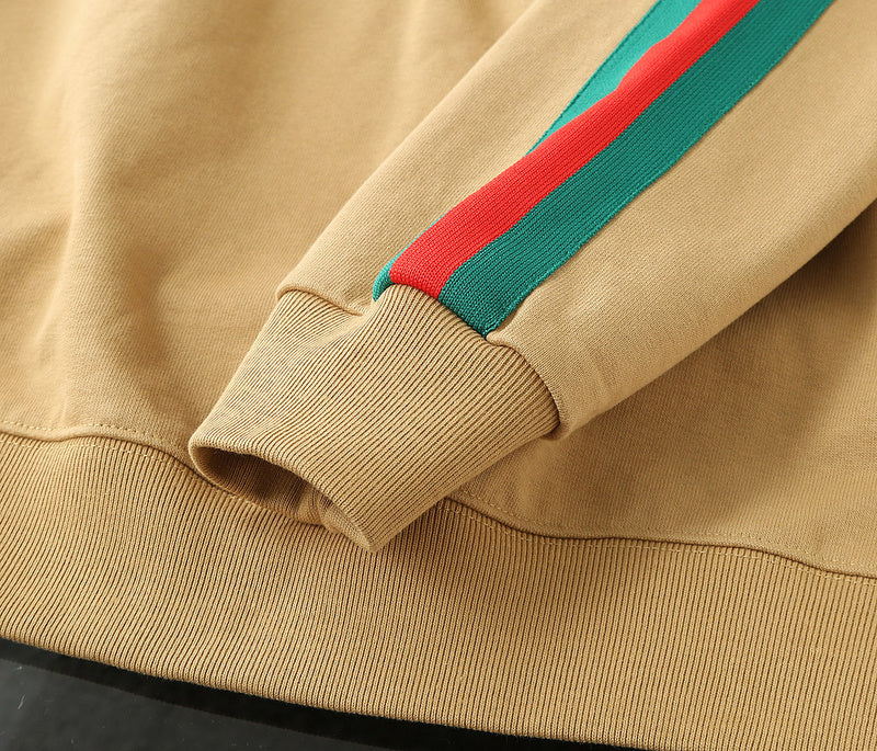 Flat lay presentation of Gucci luxury clothing with signature branding
