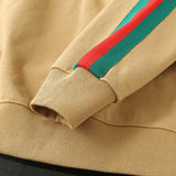 Flat lay presentation of Gucci luxury clothing with signature branding