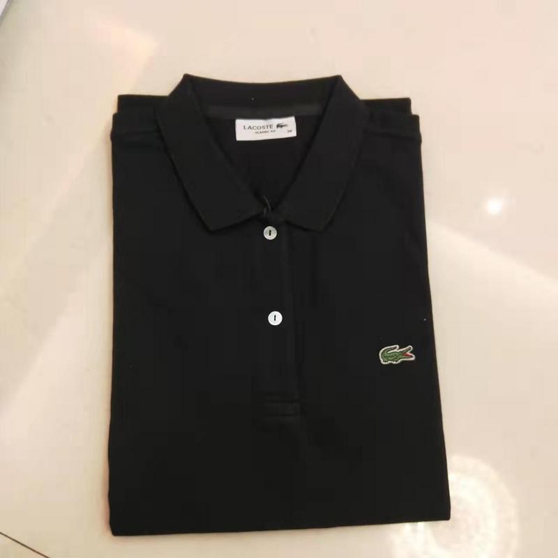Flat lay presentation of Lacoste luxury clothing with signature branding