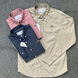 Flat lay presentation of Lacoste luxury clothing with monogram-inspired silhouette
