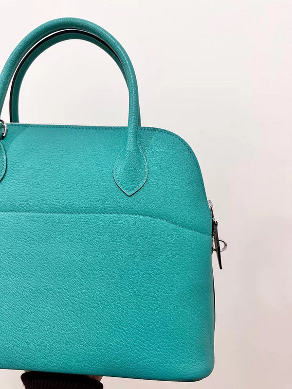 Side view of sleek structured handbag