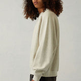 Close-up of Fear of God Essentials Sweatshirt signature hardware and stitching detail