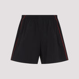 Close-up of Balenciaga bermudas hardware and fine stitching