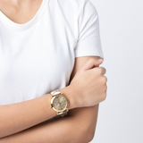 Lifestyle view of Burberry women's gold watch