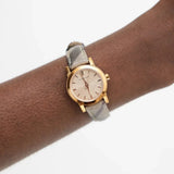 Side view of Burberry women's rose gold watch