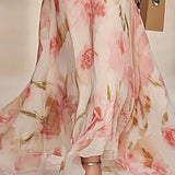 Floral dress with pink and gold flowers on a plain background