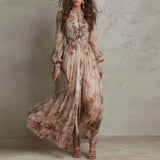 Woman wearing a long floral dress against a neutral background