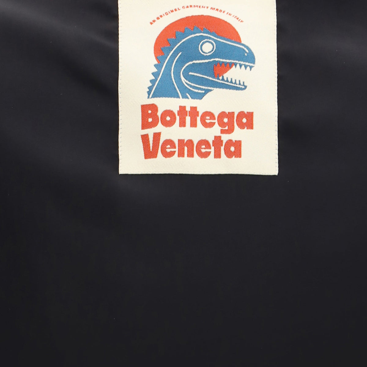 Close-up of Bottega Veneta vests hardware and fine stitching