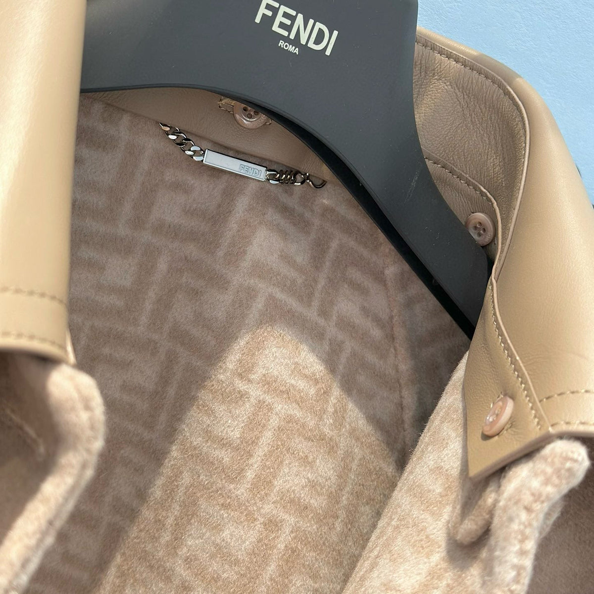 Close-up of Fendi Coat signature hardware and stitching detail