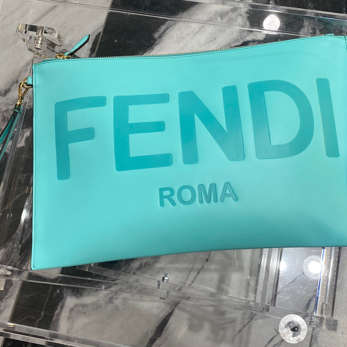 Close-up of Fendi wristlet clutch hardware and fine stitching