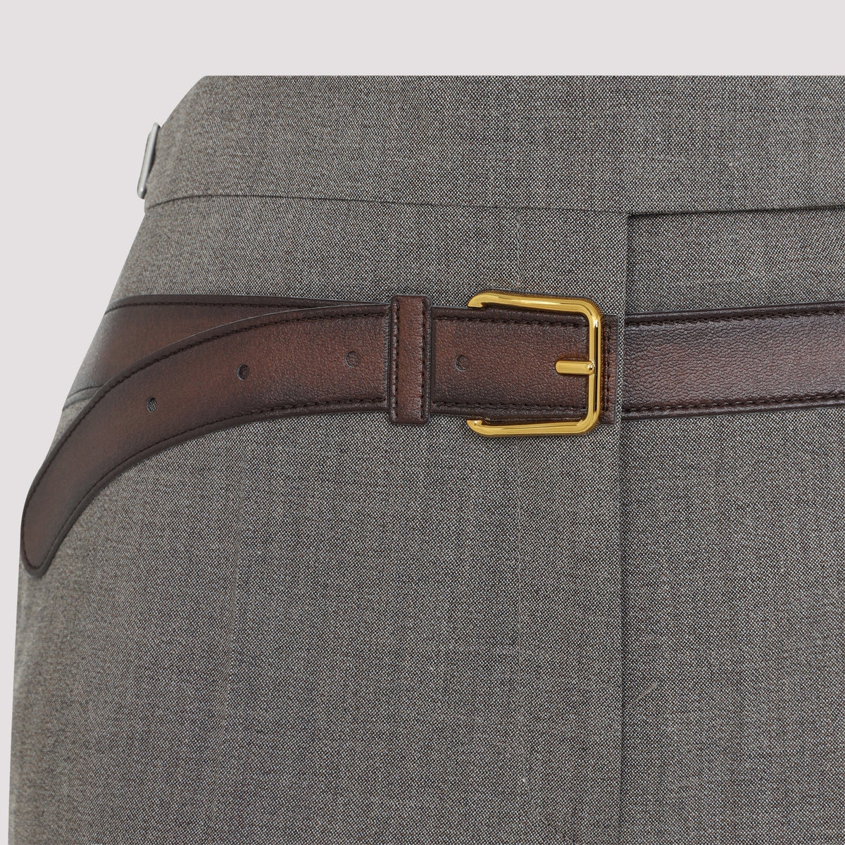 Close-up of Prada pants hardware and fine stitching