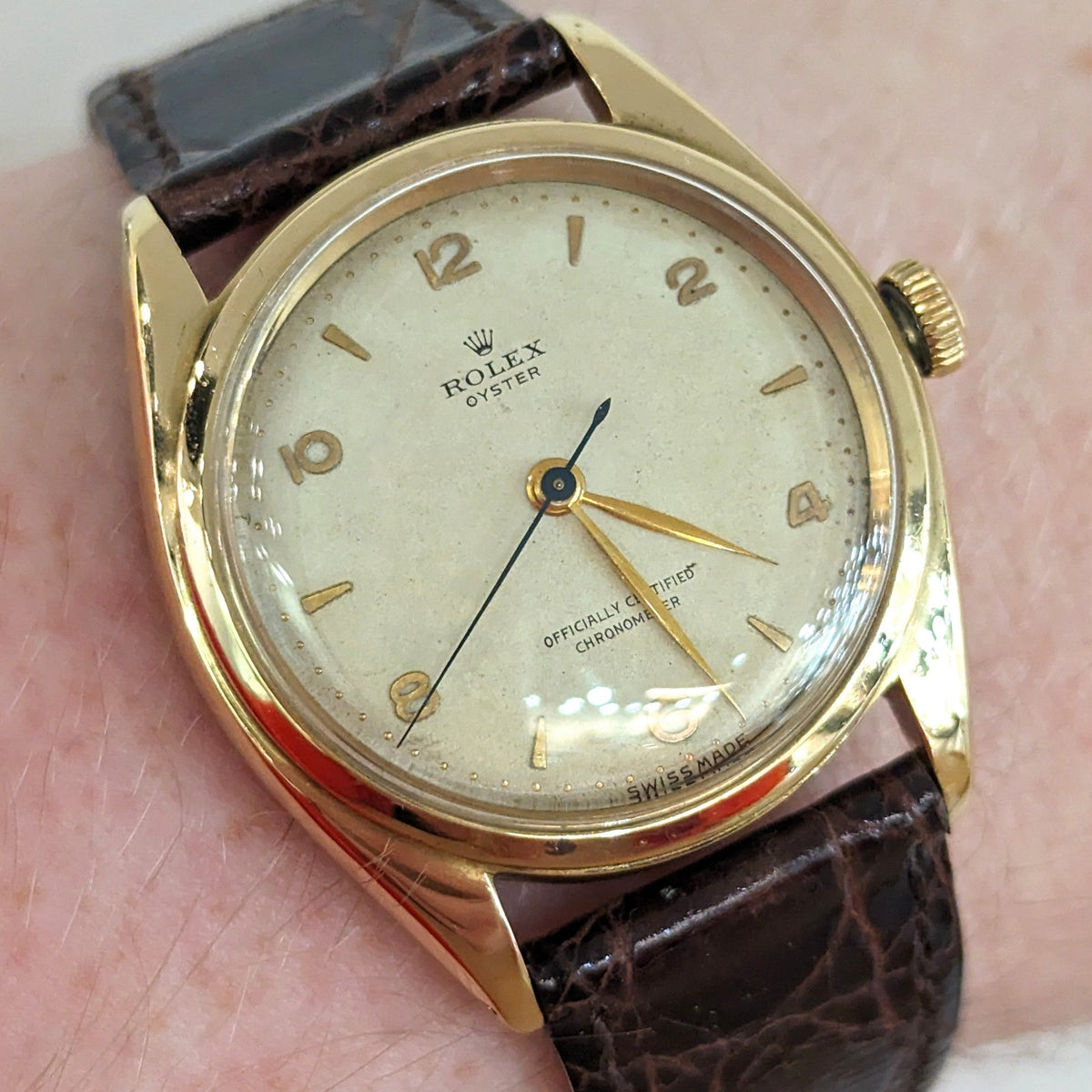 Close-up detail view of Rolex unisex gold watch